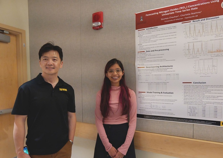 Shaoping Xiao and a student next to a research poster