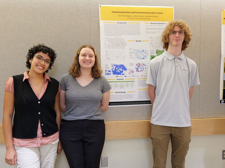 Students standing next to a poster