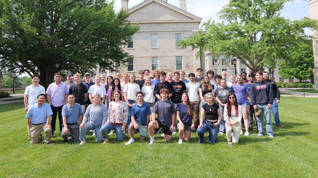 A group of people posing for a photo in front of the Old Capitol Building